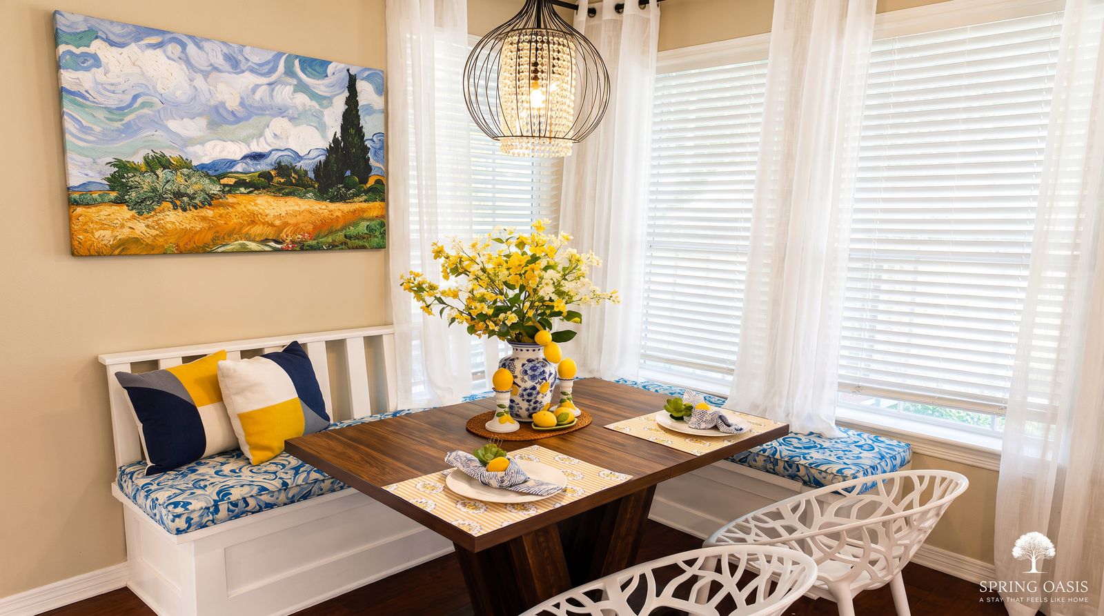 The breakfast nook with a bench, table and chandelier