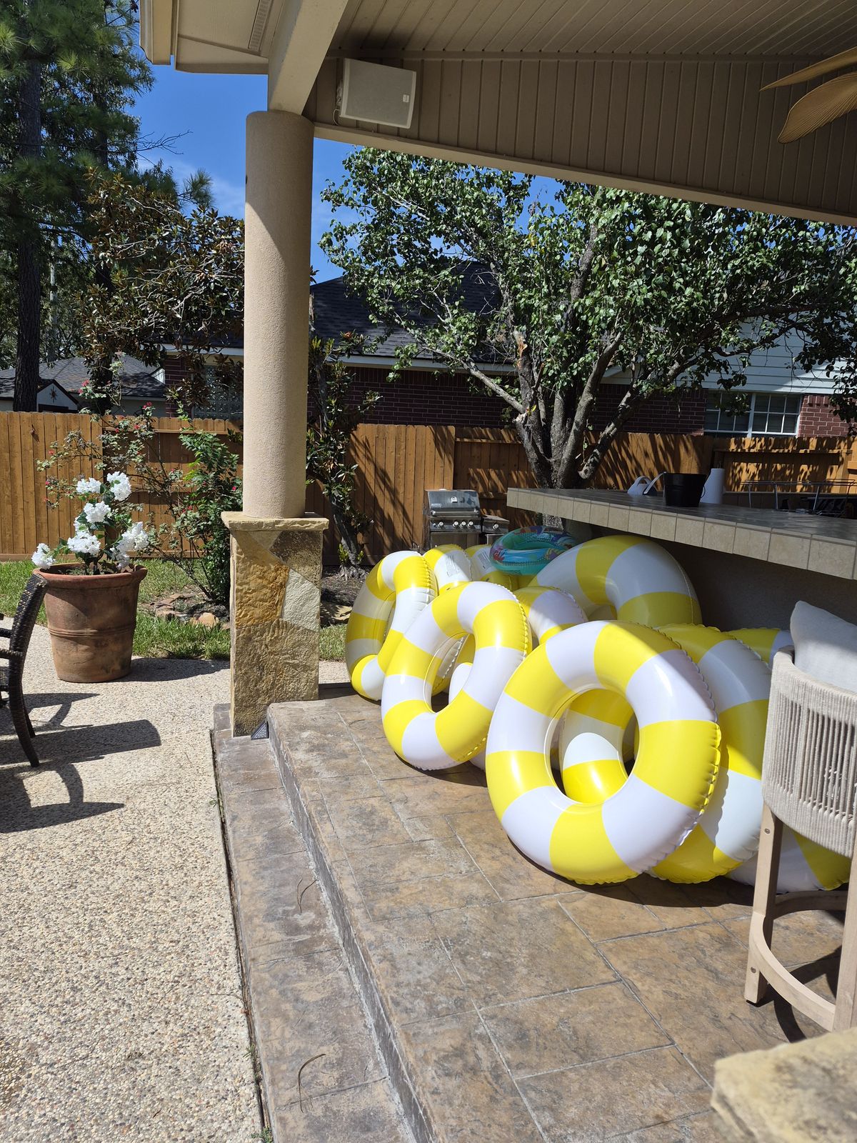The covered patio with pool floats ready